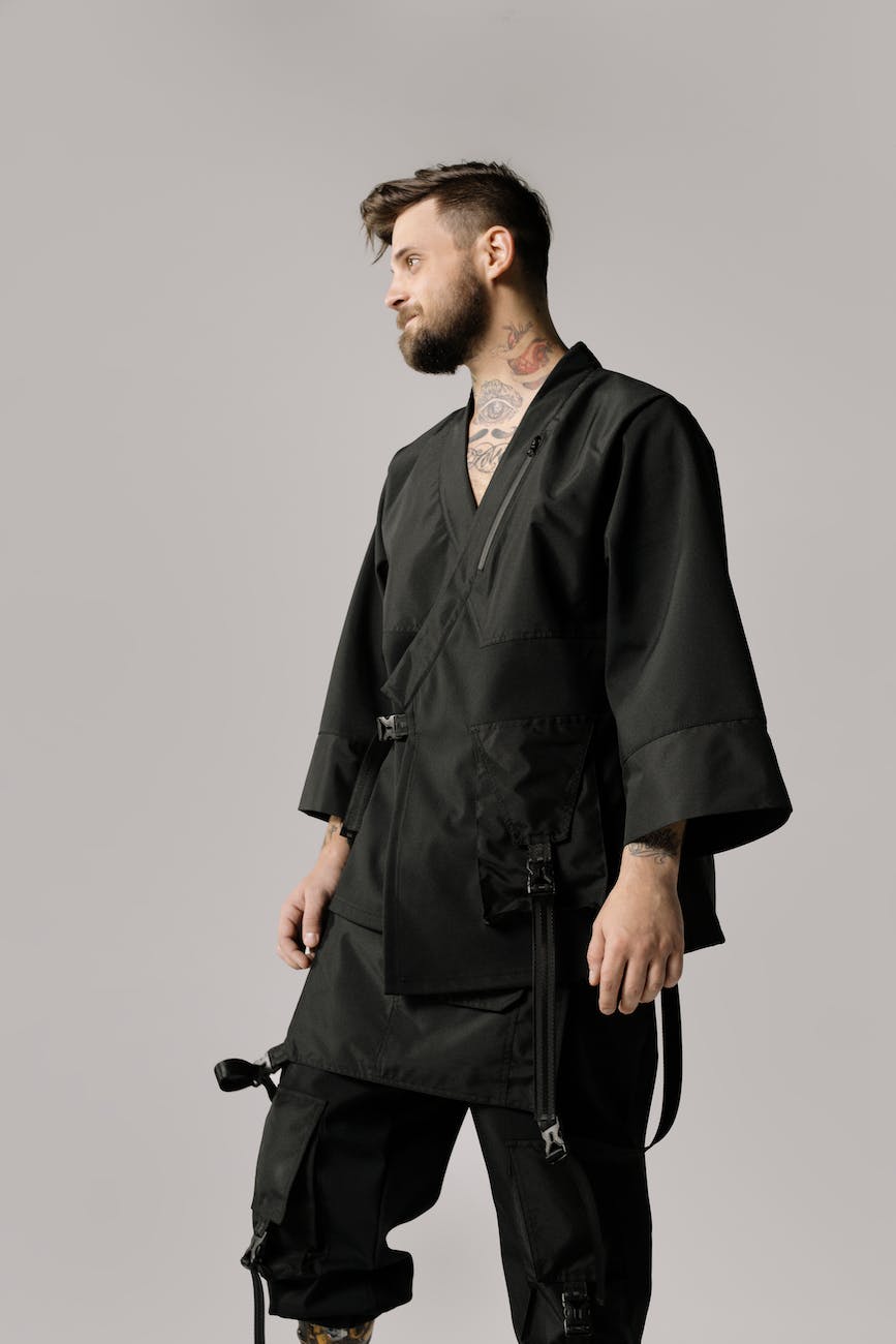a tattooed man wearing a black kimono